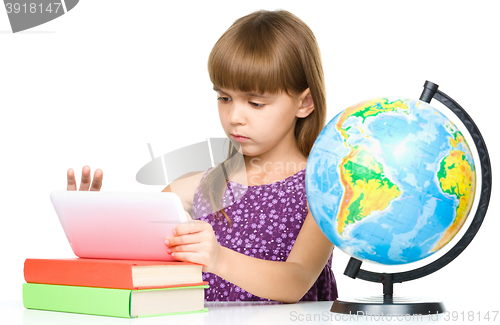 Image of Young girl is using tablet