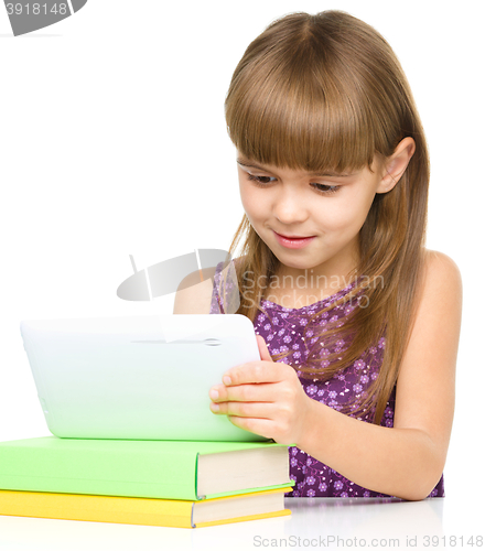 Image of Young girl is using tablet