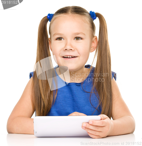 Image of Young girl is using tablet