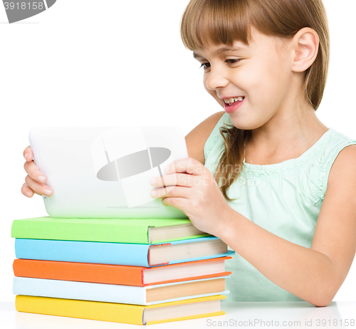 Image of Young girl is using tablet