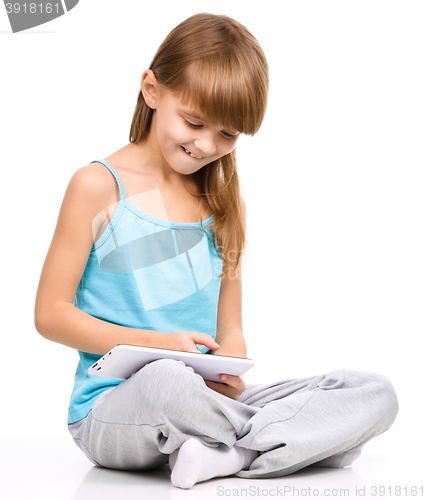Image of Young girl is using tablet