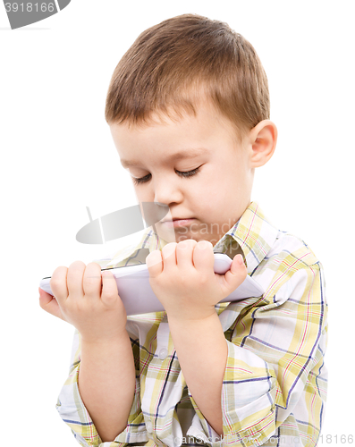 Image of Young boy is using tablet