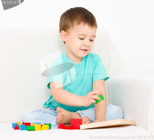 Image of Boy is playing with puzzle