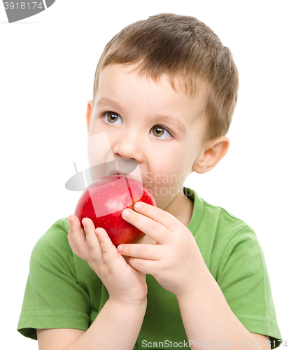 Image of Portrait of a cute little boy with red apple