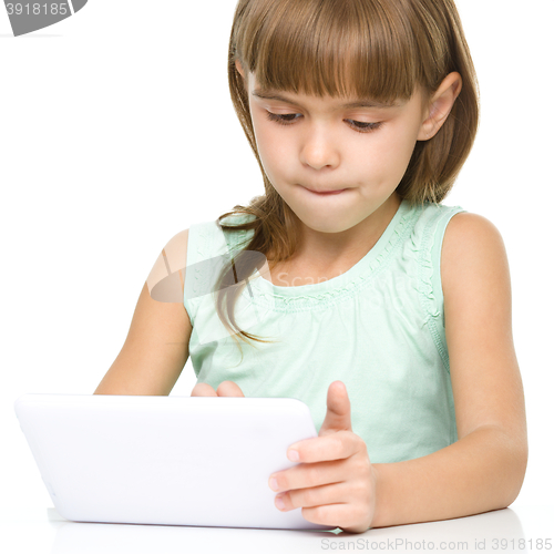 Image of Young girl is using tablet