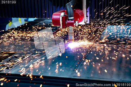 Image of CNC Laser cutting of metal, modern industrial technology.