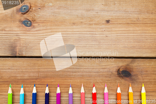 Image of close up of crayons or color pencils on wood