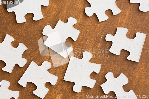 Image of close up of puzzle pieces on wooden surface