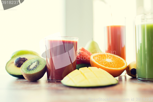 Image of close up of fresh juice glass and fruits on table