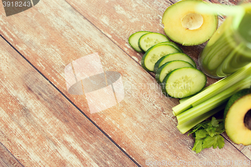 Image of close up of fresh green juice glass and vegetables