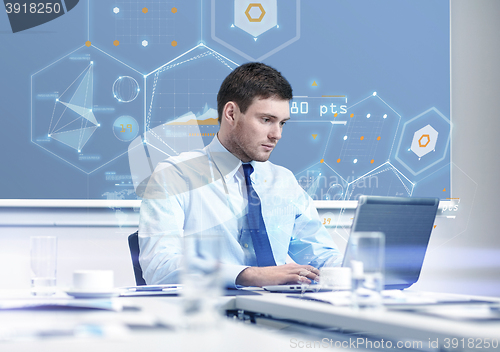 Image of businessman with laptop working in office