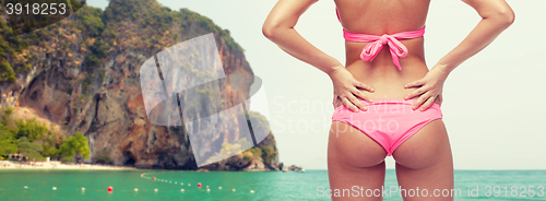 Image of close up of young woman buttocks in pink bikini