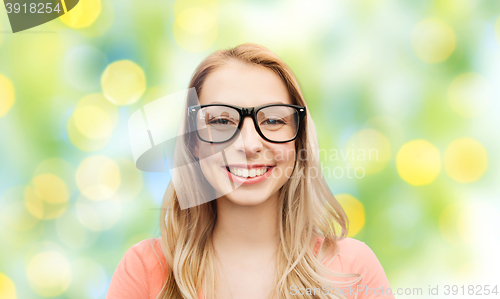 Image of happy young woman or teenage girl in eyeglasses
