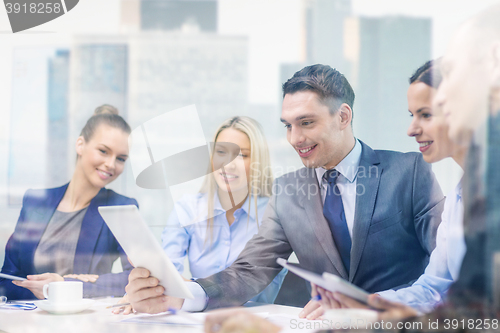 Image of business team with tablet pc having discussion