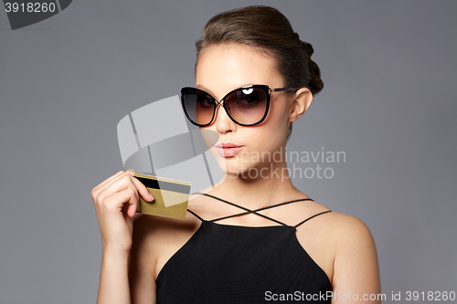 Image of beautiful young woman in elegant black sunglasses