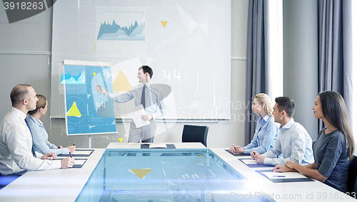 Image of group of smiling businesspeople meeting in office