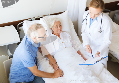 Image of senior woman and doctor with clipboard at hospital