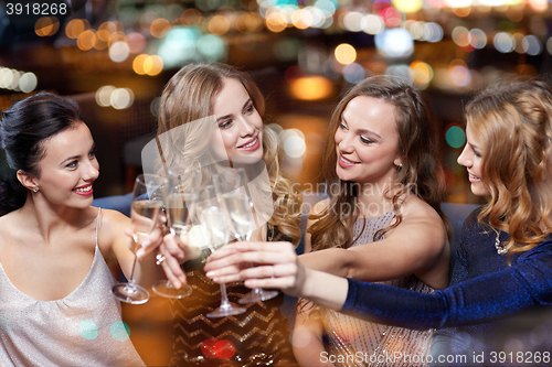 Image of happy women with champagne glasses at night club