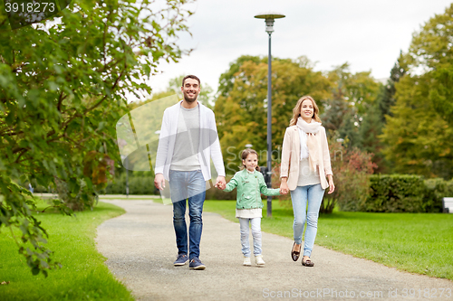 Image of happy family walking in summer park