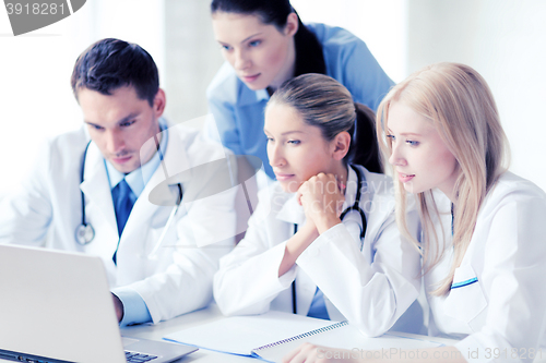 Image of group of doctors looking at tablet pc