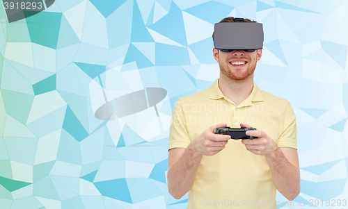 Image of happy man in virtual reality headset with gamepad