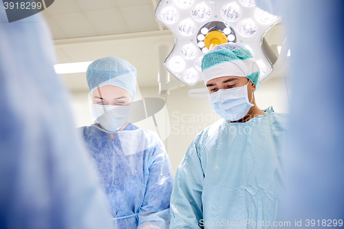 Image of group of surgeons in operating room at hospital