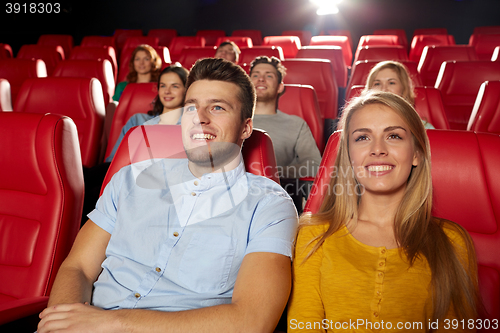 Image of happy friends watching movie in theater