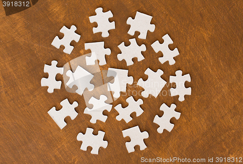 Image of close up of puzzle pieces on wooden surface