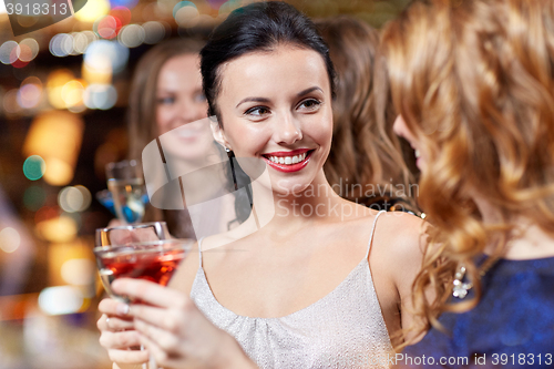 Image of happy women with drinks at night club