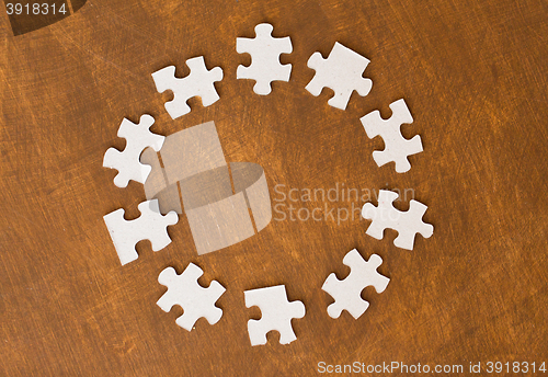 Image of close up of puzzle pieces on wooden surface