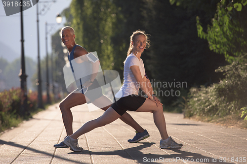 Image of couple warming up and stretching before jogging