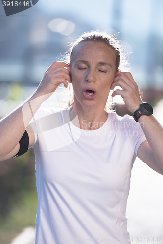 Image of jogging woman setting phone before jogging