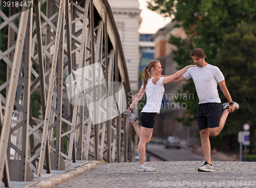 Image of couple warming up and stretching before jogging