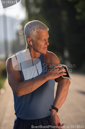 Image of portrait of handsome senior jogging man