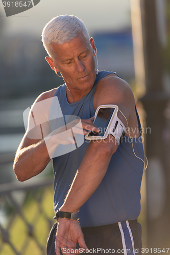 Image of portrait of handsome senior jogging man