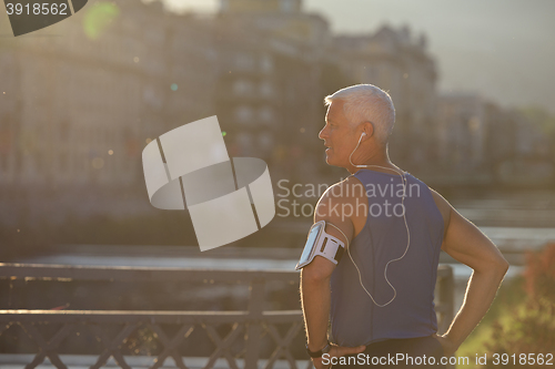 Image of portrait of handsome senior jogging man