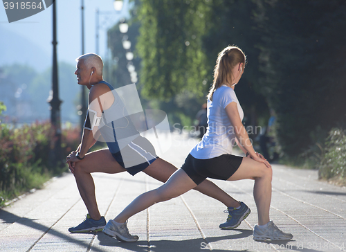 Image of couple warming up and stretching before jogging