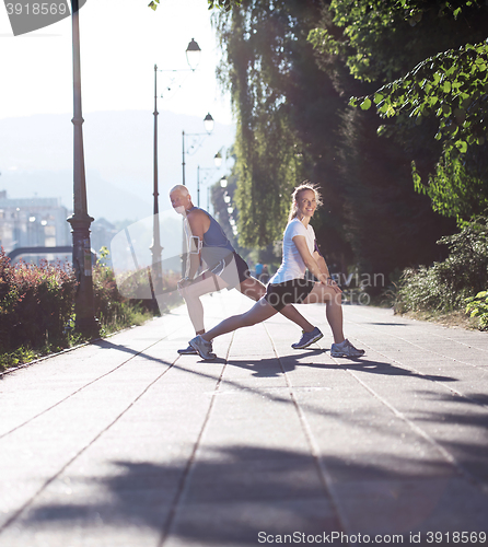 Image of couple warming up and stretching before jogging