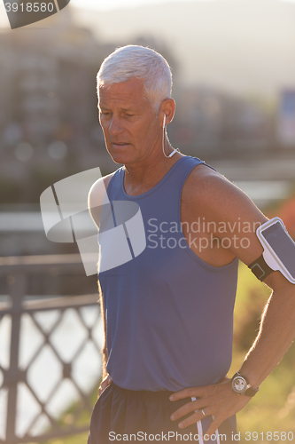 Image of portrait of handsome senior jogging man