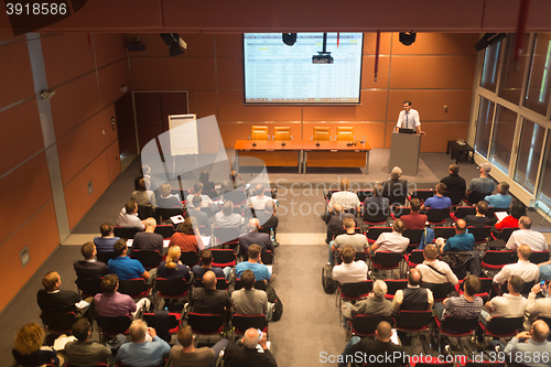 Image of Business speaker giving a talk in conference hall.