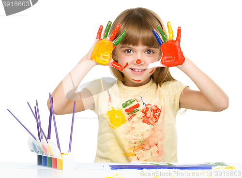 Image of Portrait of a cute girl playing with paints