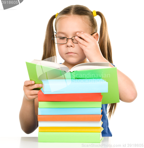 Image of Little girl is reading a book