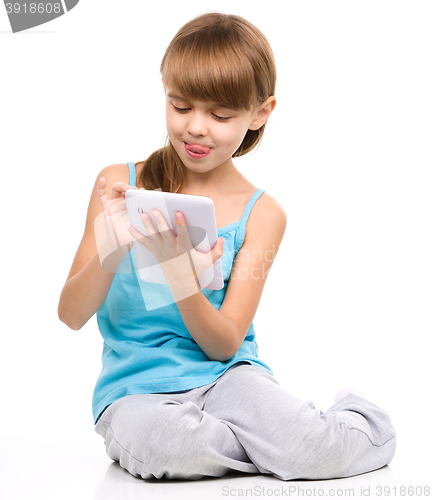 Image of Young girl is using tablet