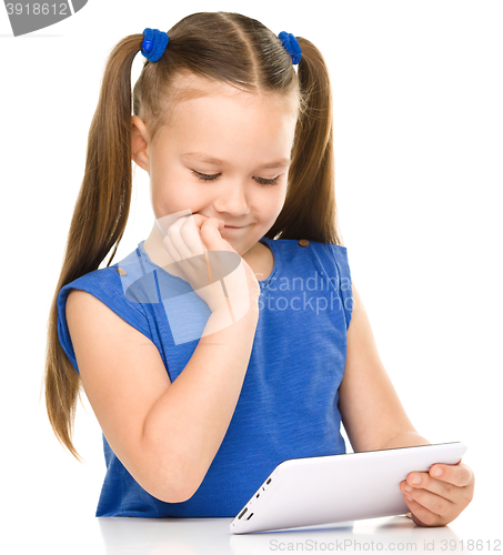 Image of Young girl is using tablet