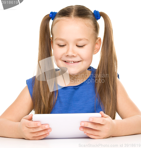Image of Young girl is using tablet