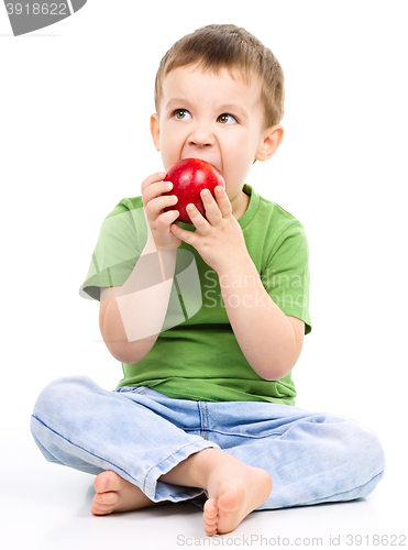 Image of Portrait of a cute little boy with red apple