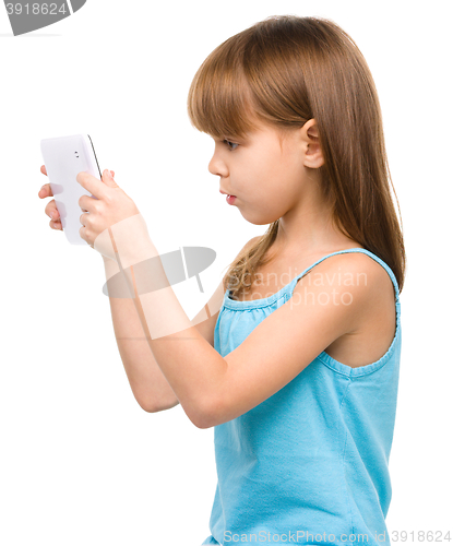 Image of Young girl is using tablet