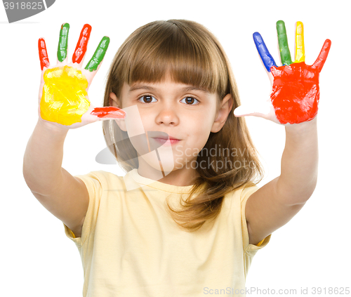 Image of Portrait of a cute girl playing with paints