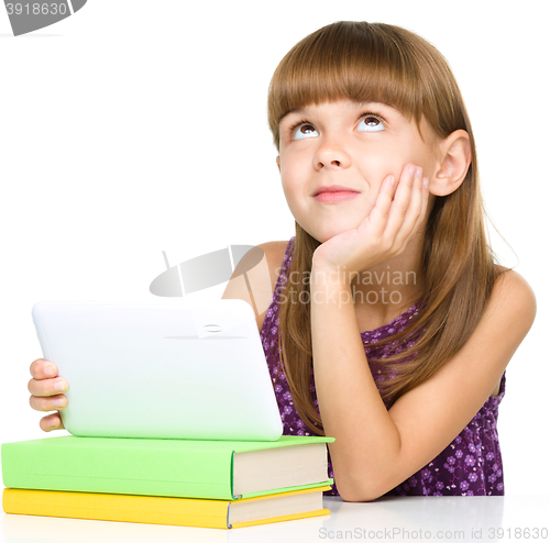 Image of Young girl is using tablet