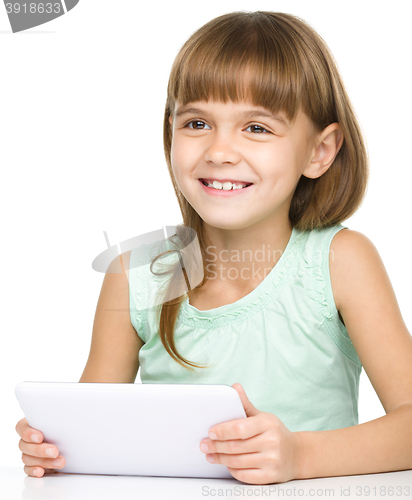 Image of Young girl is using tablet